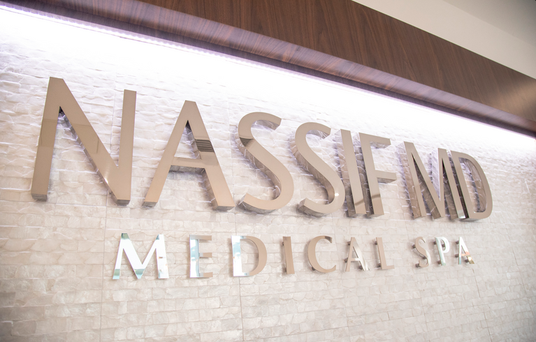 Treatment lounge with skincare displays at NassifMD Medical Spa Manchester
